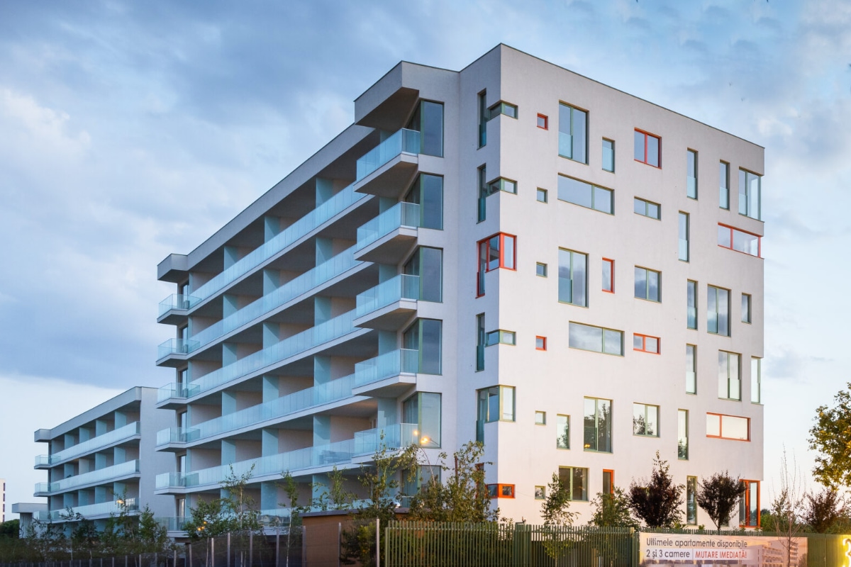 A completed modern residential building at dusk, ready for handover